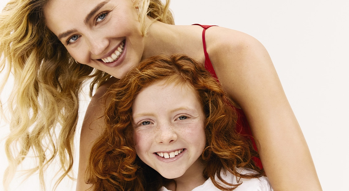 Woman and girl smiling at the camera
